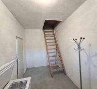 Attic storage space with a wooden ladder in a family house.