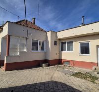 A family house in Ludanice, with a yard and a white facade.