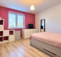 Children's room with a crib, wardrobe, toys, and a floor with a wooden decor in a family house.