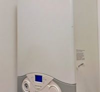 Gas boiler in a family house with a digital display and a white panel.