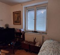 A room in a family house with a bed, a television, and a dresser.