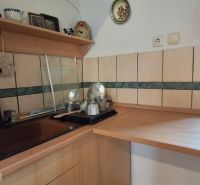 A kitchen nook in a family house with a wooden decor and a window.