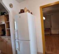 A kitchen in a family house with a wooden decor.