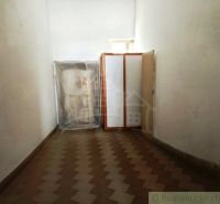 A narrow space with a wooden decor floor and storage space in commercial premises.