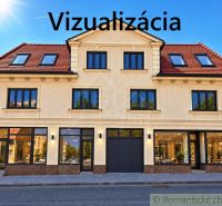 The facade of a building with commercial spaces in the town of Modrý Kameň, capturing glass display windows.