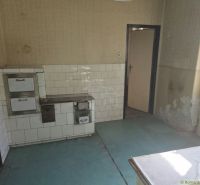 Interior of a commercial space with a traditional stove and decorated walls.