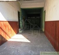 Garage in the commercial premises of Modrý Kameň with walls with wooden paneling.