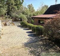A peaceful cottage near Modrý Kameň with a terrace and landscaped greenery suitable for relaxation.