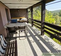 A view from the cottage in Modrý Kameň, a terrace with seating surrounded by nature.