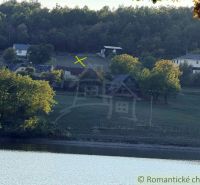 A view of the rural landscape and lake around Krupina with gardens and houses.