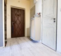A hallway with a wooden decor floor in a 2-room apartment.