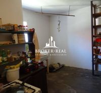 Kitchen in a family house with shelves full of kitchen utensils and ingredients.