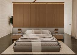 A bedroom in a minimalist style with a large bed and wooden elements. House construction.