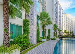 Apartment construction in Pattaya with a pool and greenery in an attractive environment.