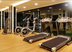 Gym with equipment under construction of apartments, treadmills and stationary bikes.