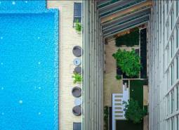 A view from above of the pool and terrace of apartment constructions in Pattaya.