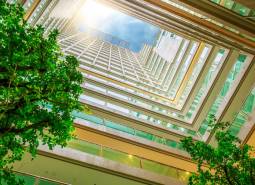 View from the atrium on the apartment construction, with the logo of 1BCR Real Estate Group.