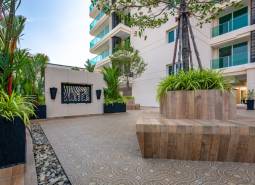 Construction of apartments in Pattaya with modern architecture and greenery around the buildings.