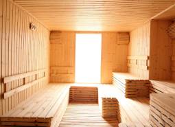 Wooden sauna with benches, natural light; Apartment construction.