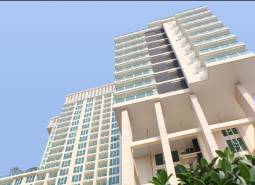 Apartment construction in Pattaya, a high-rise building with glass windows and balconies.