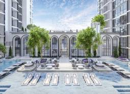 Apartment construction in Pattaya with a garden, swimming pool, and sun loungers.