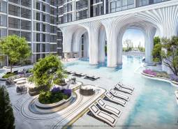 Apartment construction in Pattaya: pool, loungers, greenery, modern architecture, exterior, sunny location.
