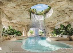 The interior space with a pool resembles a cave, with a waterfall and plants around.
