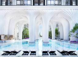 Luxury apartment development with a pool and white columns reminiscent of futuristic architecture.