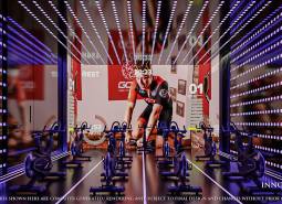 Fitness studio with exercise bikes and a projected screen under construction in an apartment building.