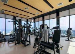 Fitness center in an apartment building with a view of Pattaya.