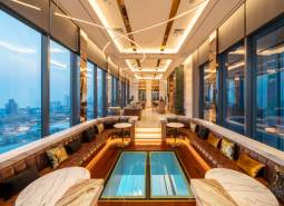 Luxurious interior with panoramic views, sofas, and marble tables within the apartment construction.
