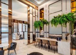 Luxurious interior with white marble furniture and green plants in apartment construction.