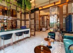 Interior of a luxurious living room with a bar counter and designer furniture. Apartment construction.
