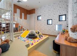 Children's corner with a ball pool and games as part of apartment construction.