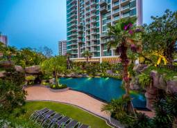 Apartment construction in Pattaya, with a swimming pool and tropical garden.