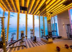 Fitness center with a sea view and modern equipment within the apartment development.