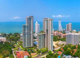 Apartment construction in Pattaya, high-rise buildings by the coast with a sea view.