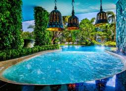 Luxury pool with green plants and lamps, Apartment construction in Pattaya.