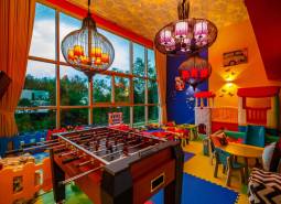 Children's playroom with a football table and indoor games in apartment construction.
