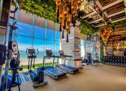 Luxury gym with a beach view within the apartment development.