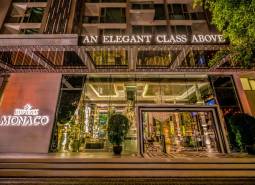Entrance to the Apartment Complex with a lit sign in Pattaya, luxuriously furnished interior.