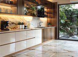 A kitchen in an apartment under construction with a marble floor and a view of the garden.