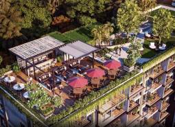 Rooftop garden with a terrace in a residential complex in Pattaya surrounded by greenery.