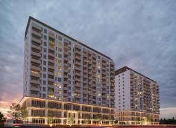 Construction of apartments on Panónska Road in Bratislava - Petržalka. Two illuminated apartment buildings.