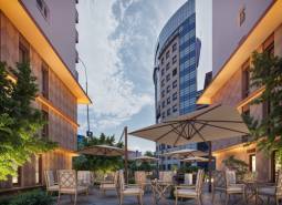 Construction of apartments on Panónska Road in Bratislava - Petržalka with a sunny terrace and garden furniture.