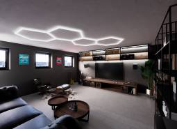 Interior of commercial spaces with seating, a television, and decorative elements.