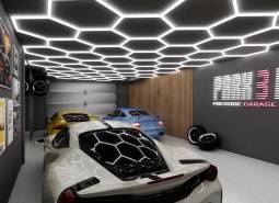 Commercial premises with a garage, luxury cars, impressive lighting, and decorations on the walls.