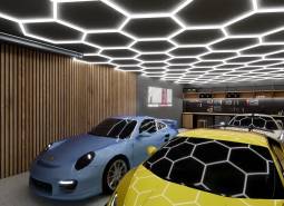 Commercial spaces with parked sports cars and modern ceiling lighting.