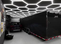 Commercial space with a car, trailer, light ceiling, and art posters on the wall.