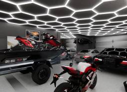 Showroom with cars, a motorcycle, and a jet ski under hexagonal lighting.